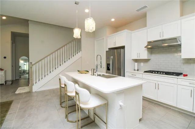 a kitchen that has a table and chairs in it