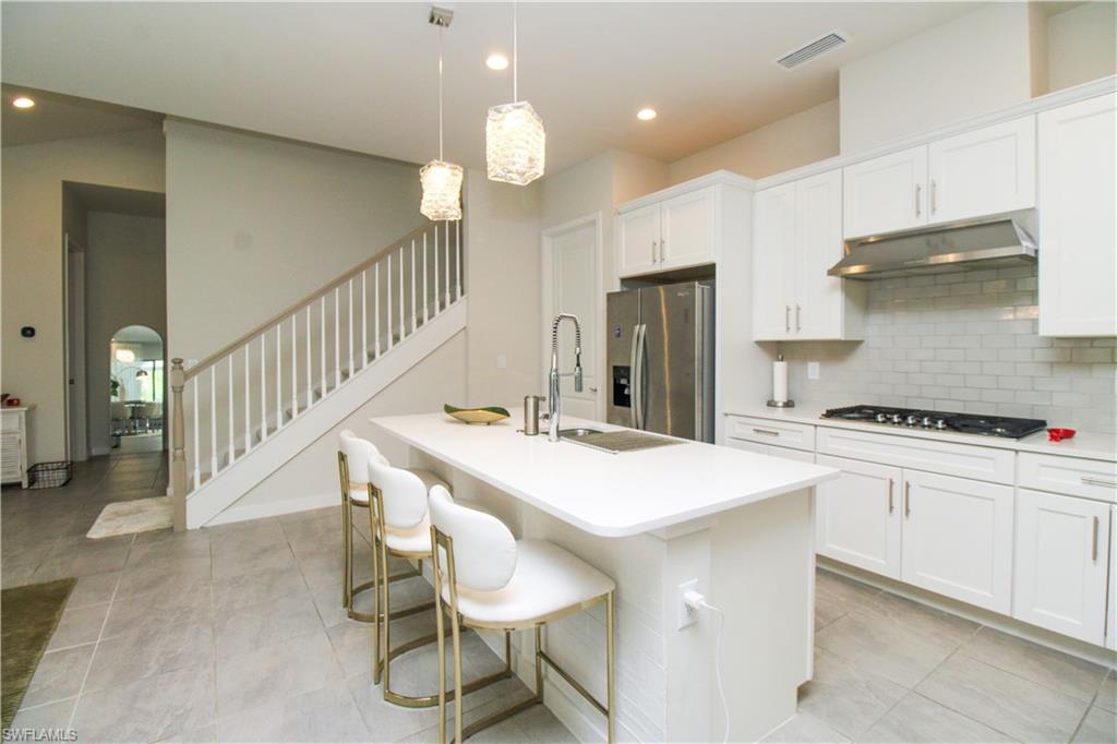 14803 Loggerhead Drive Naples, FL 34120 - Photo 27 of 50 a kitchen that has a table and chairs in it
