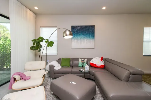 a living room with furniture and a potted plant