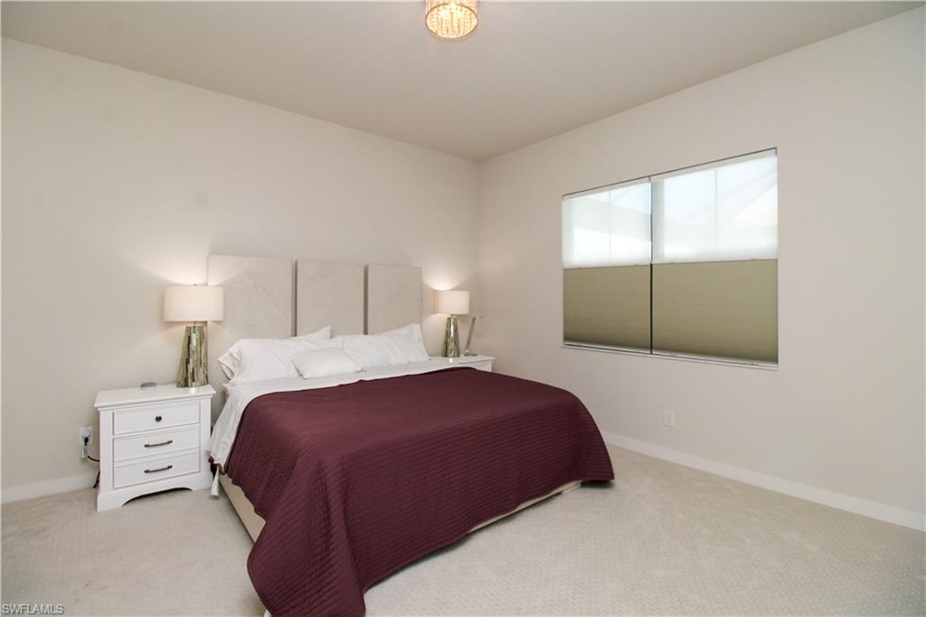 14803 Loggerhead Drive Naples, FL 34120 - Photo 34 of 50 a bedroom with a bed and a window
