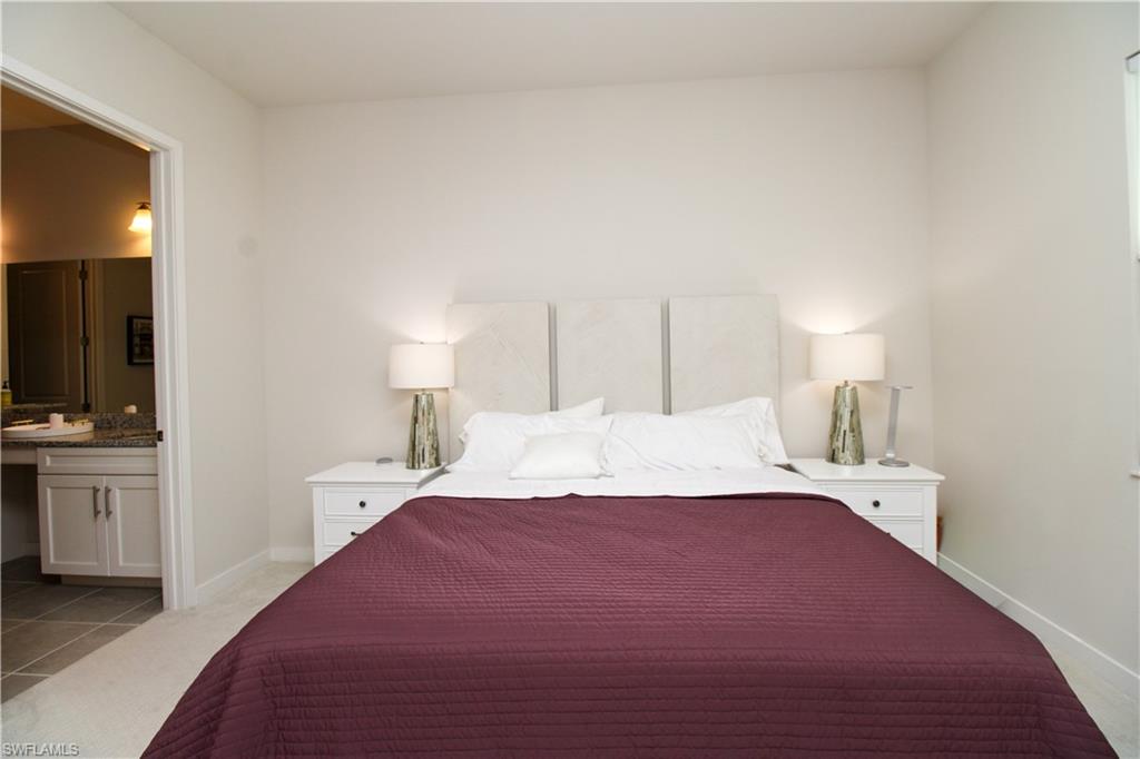 14803 Loggerhead Drive Naples, FL 34120 - Photo 35 of 50 a bedroom with a bed and a lamp