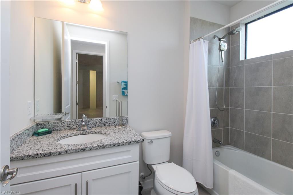14803 Loggerhead Drive Naples, FL 34120 - Photo 46 of 50 a bathroom with a granite countertop sink toilet and shower