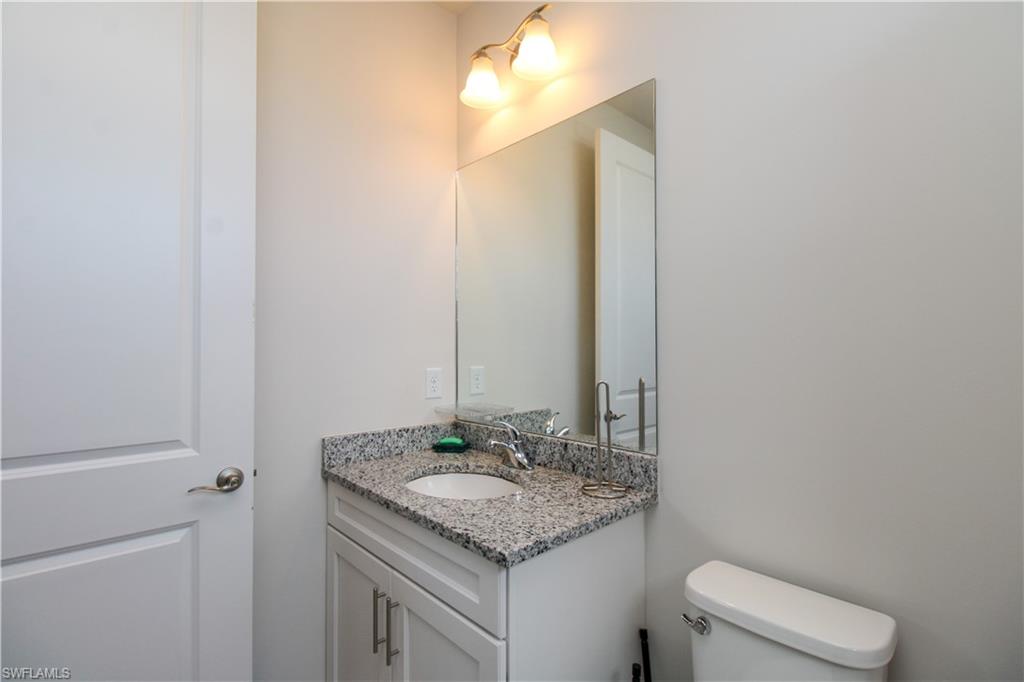 14803 Loggerhead Drive Naples, FL 34120 - Photo 47 of 50 a bathroom with a granite countertop sink and a mirror