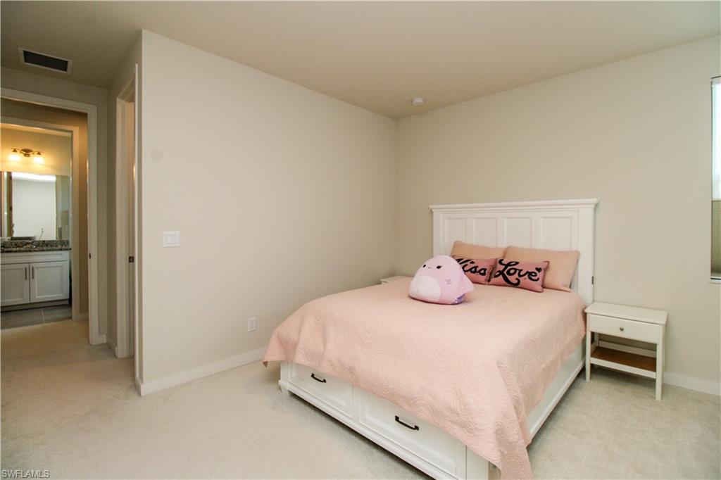 14803 Loggerhead Drive Naples, FL 34120 - Photo 49 of 50 a bedroom with a bed and a cabinets