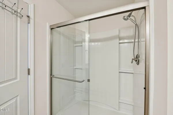 a bathroom with a glass shower door
