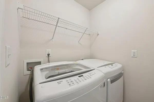 a patio with table and chairs and a barbeque