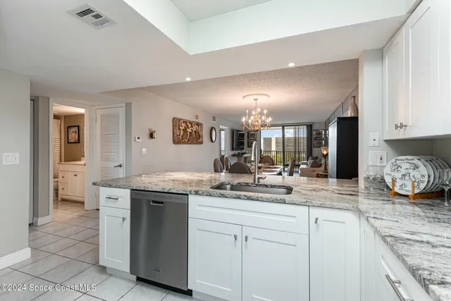 a kitchen with sink stove and cabinets