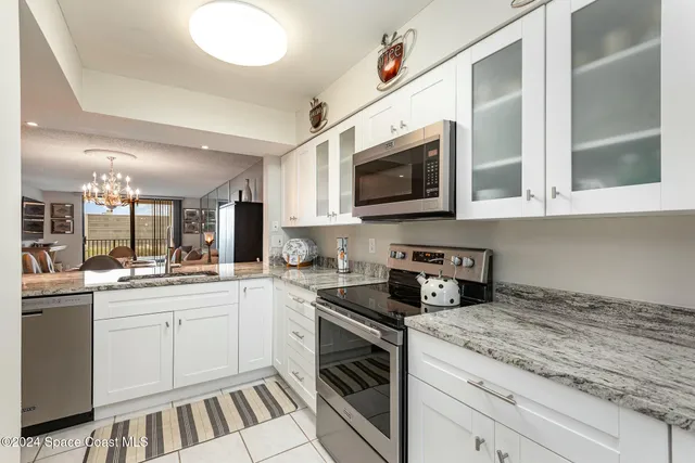a kitchen with stainless steel appliances granite countertop a stove and a sink