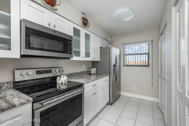 a kitchen with stainless steel appliances a stove a microwave and cabinets