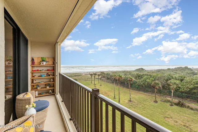 a view of a balcony with ocean view