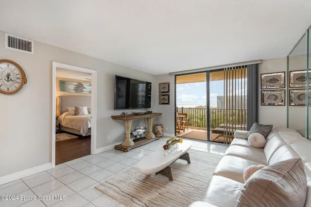 a bedroom with furniture and a large window