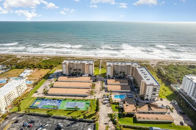a view of a room with floor to ceiling window and outdoor kitchen
