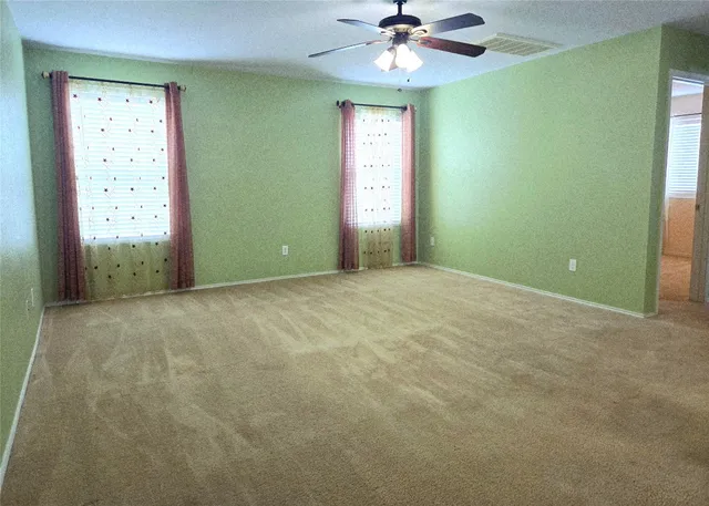 an empty room with window and closet area