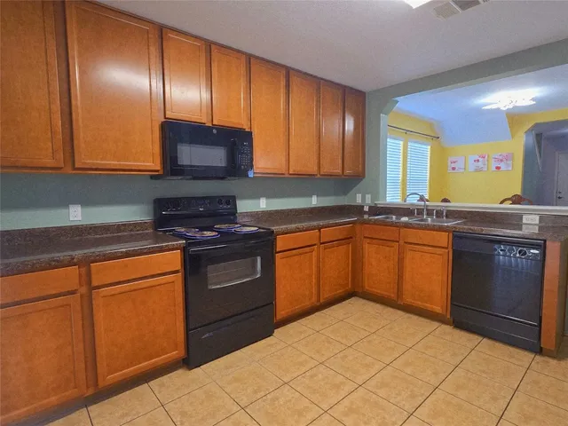 a kitchen with stainless steel appliances granite countertop a stove sink and cabinets