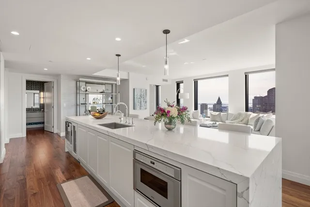 a kitchen with sink stove and wooden floor