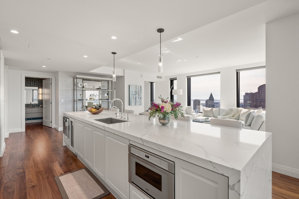 110 Sudbury Street, Unit 4002 Boston, MA 02114 - Photo 15 of 42 a kitchen with sink stove and wooden floor