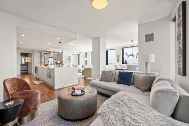 a living room with furniture and kitchen view
