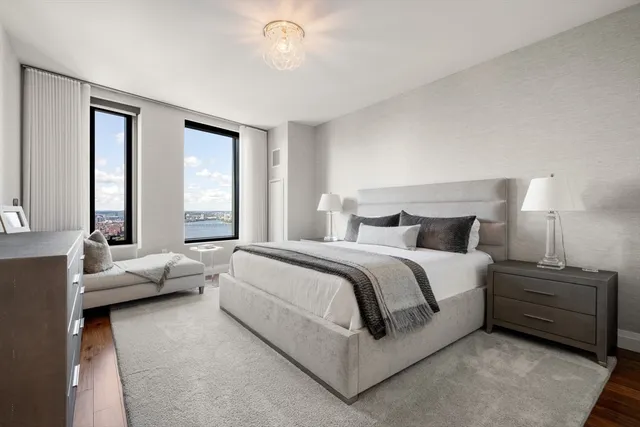 a spacious bedroom with a bed and large window