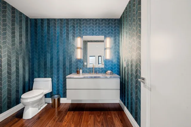 a bathroom with a sink a toilet and a mirror