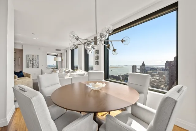 a dining room with furniture and a chandelier