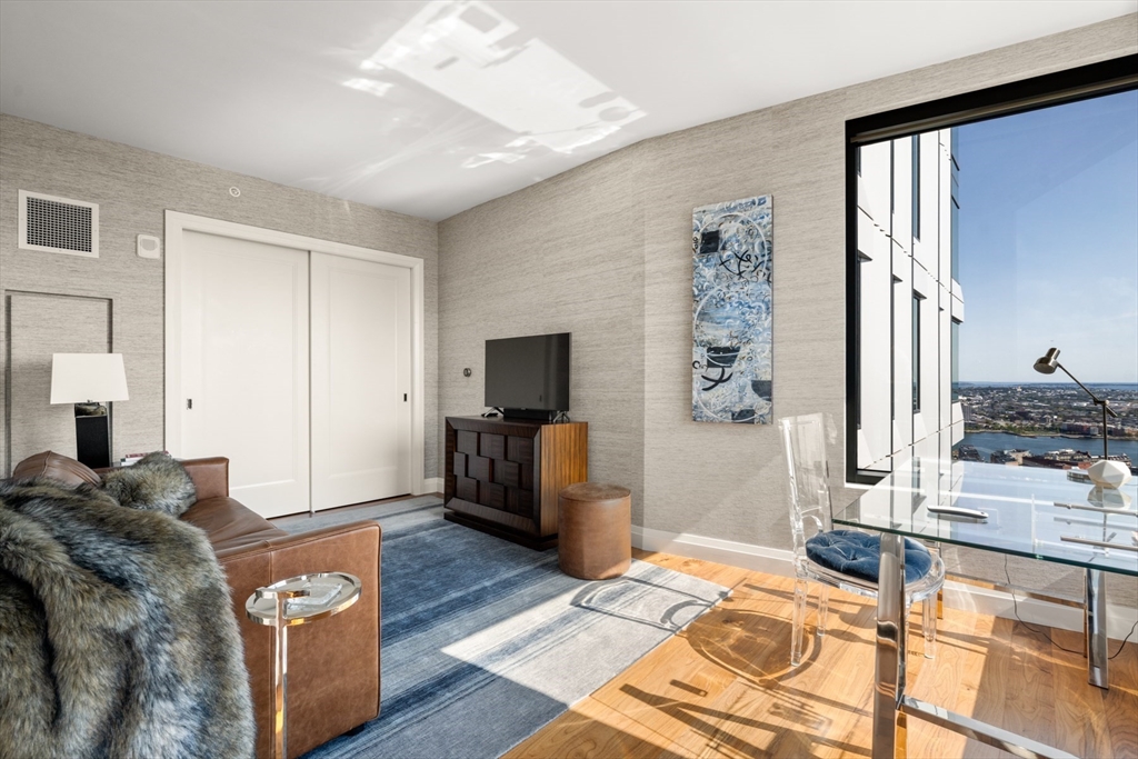 110 Sudbury Street, Unit 4002 Boston, MA 02114 - Photo 8 of 42 a bed room with a bed a television and dresser