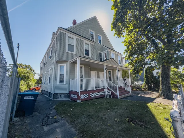 a view of a house with backyard and a tree