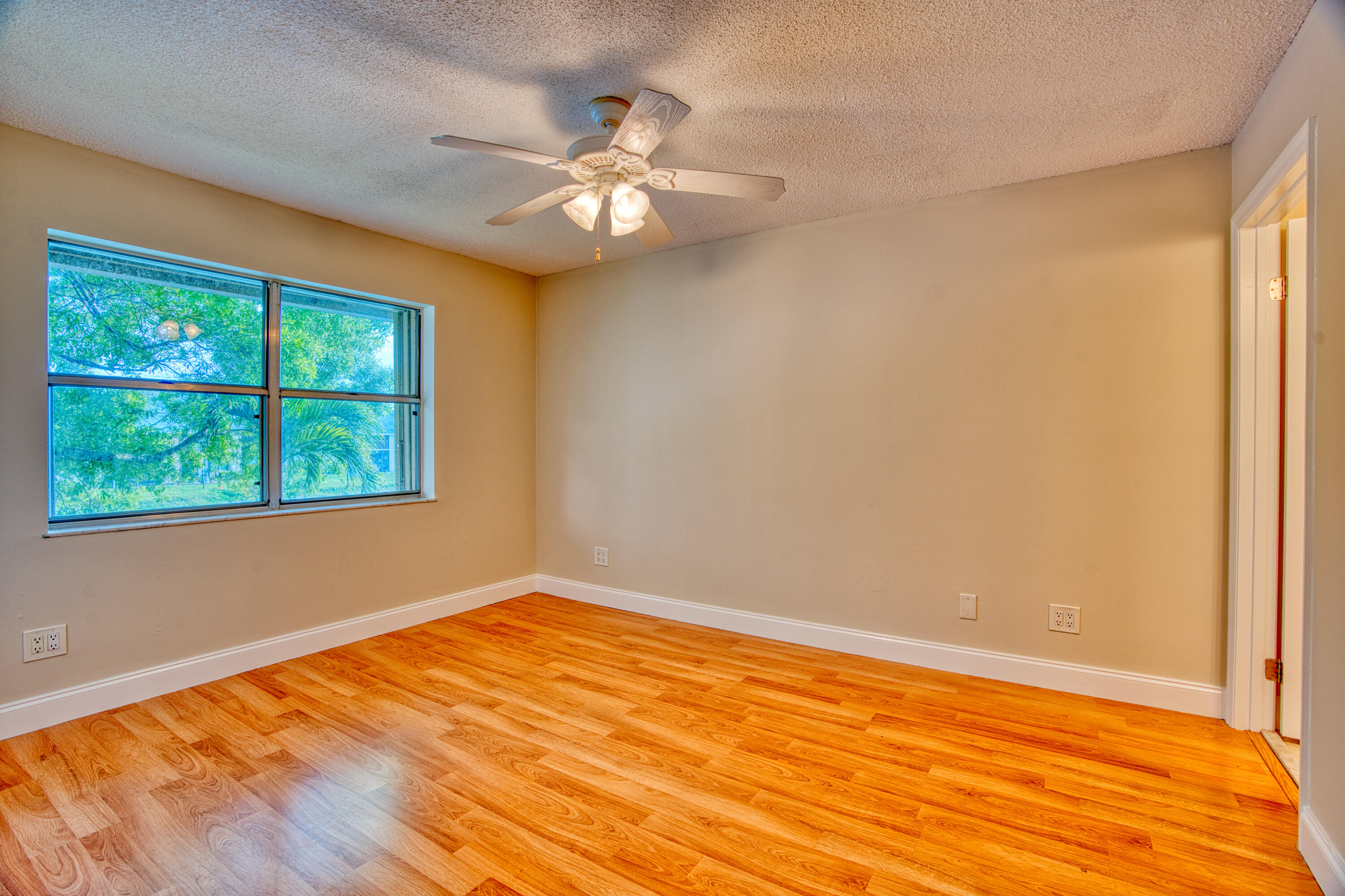 3151 Southeast Aster Lane, Unit 1306 Stuart, FL 34994 - Photo 15 of 27 en empty room with window and wooden floor