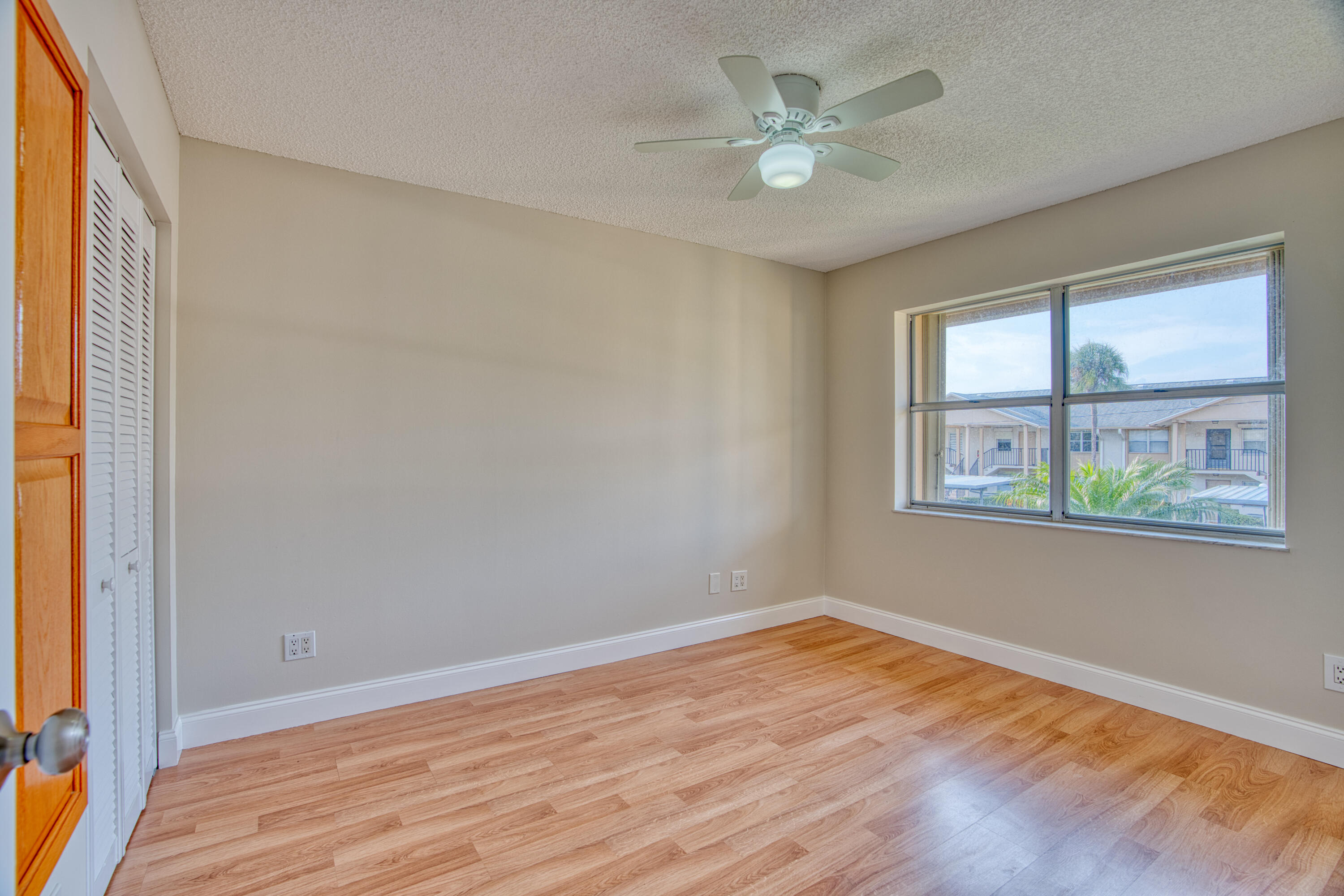 3151 Southeast Aster Lane, Unit 1306 Stuart, FL 34994 - Photo 21 of 27 wooden floor in an empty room with a window