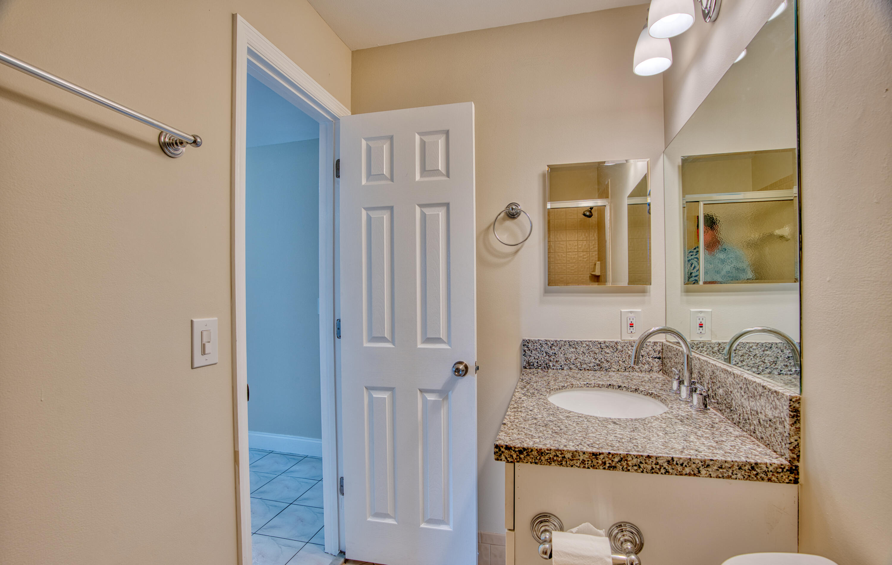 3151 Southeast Aster Lane, Unit 1306 Stuart, FL 34994 - Photo 24 of 27 a bathroom with a granite countertop sink a mirror and shower