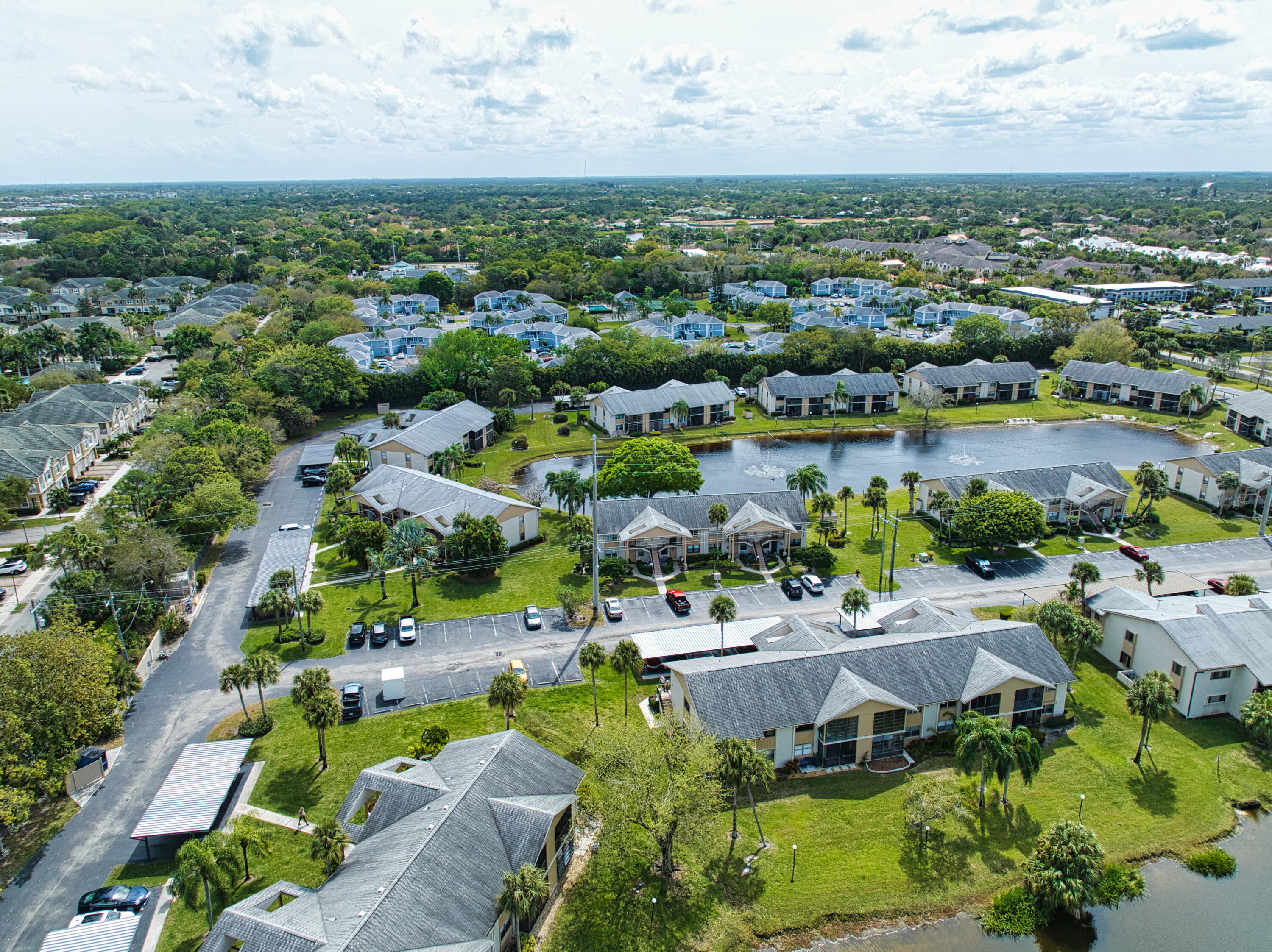3151 Southeast Aster Lane, Unit 1306 Stuart, FL 34994 - Photo 26 of 27 an aerial view of residential houses with outdoor space