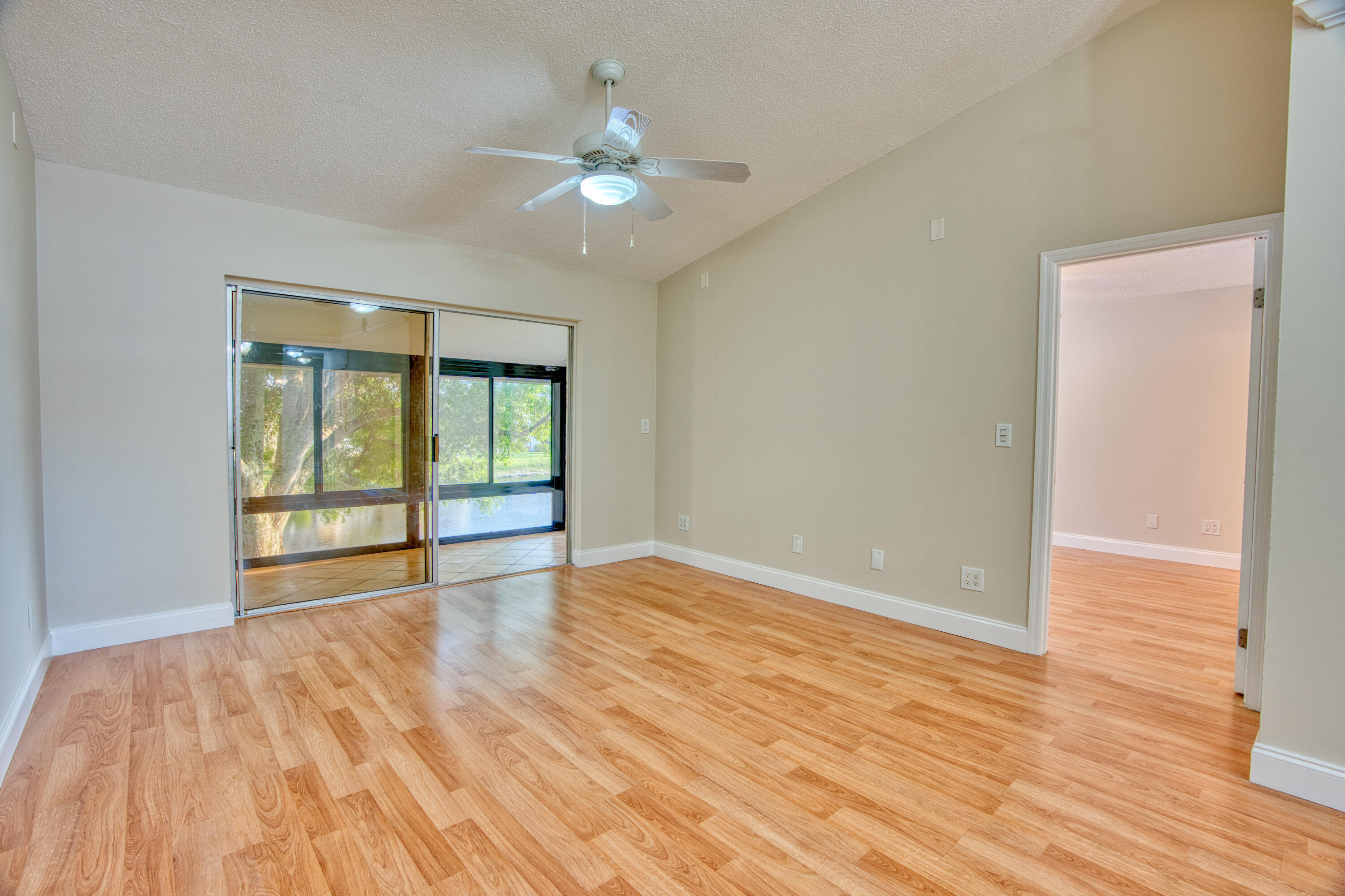 3151 Southeast Aster Lane, Unit 1306 Stuart, FL 34994 - Photo 9 of 27 a view of an empty room with wooden floor and a window