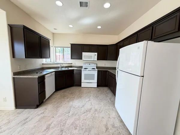 a kitchen with stainless steel appliances a refrigerator stove microwave and sink