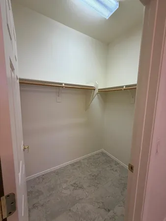 an empty room with a ceiling fan and a window