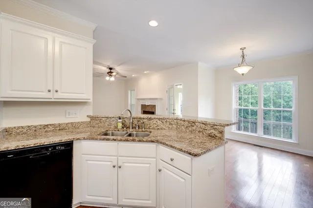 a kitchen with sink cabinets and chandelier