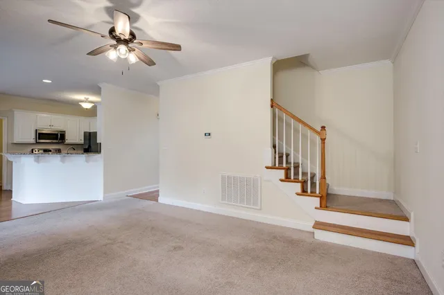 a view of livingroom with hardwood floor and a ceiling fan