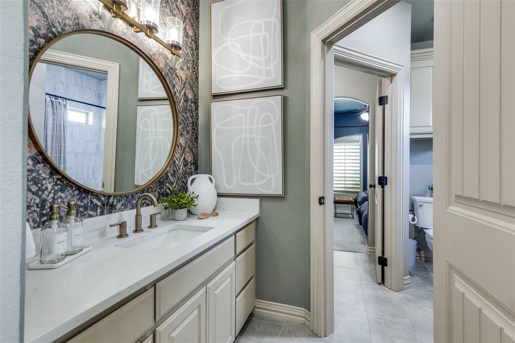 1150 Lone Star Road Bowie, TX 76230 - Photo 26 of 38 a bathroom with a sink and a mirror