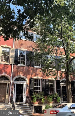 a view of house with a tree in front of it