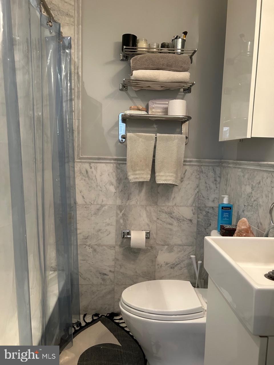 277 South 4th Street, Unit 1F Philadelphia, PA 19106 - Photo 11 of 12 a bathroom with a sink a toilet and a mirror