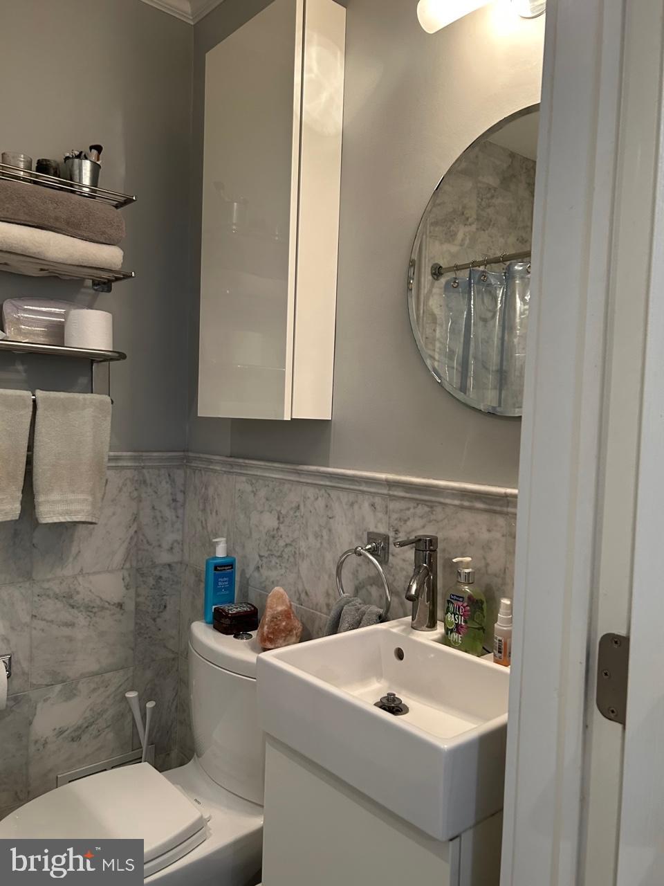 277 South 4th Street, Unit 1F Philadelphia, PA 19106 - Photo 12 of 12 a bathroom with a sink and a mirror