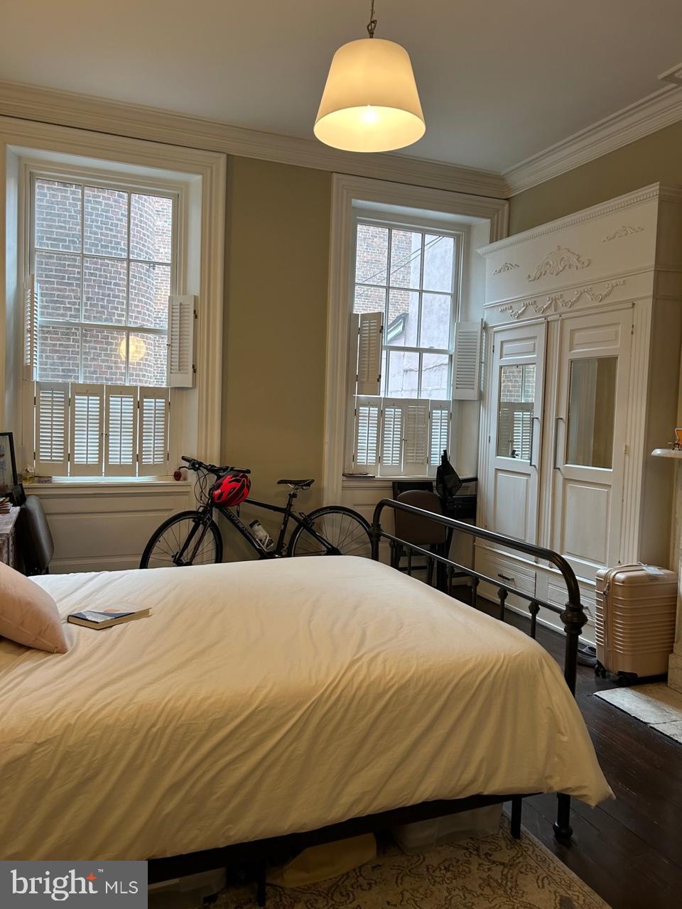 277 South 4th Street, Unit 1F Philadelphia, PA 19106 - Photo 9 of 12 a bedroom with two beds and a large window