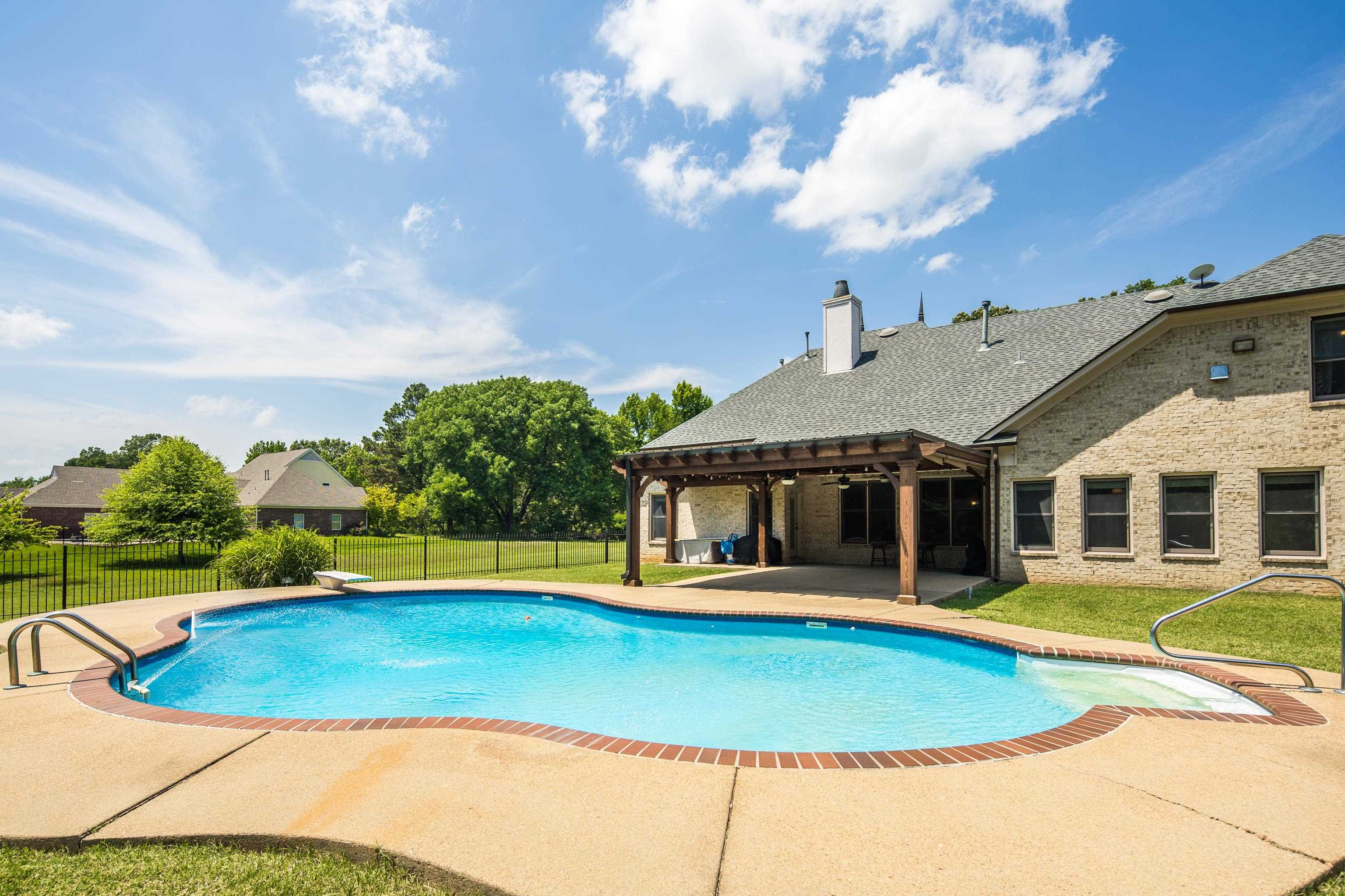 9028 Osborntown Road Arlington, TN 38002 - Photo 38 of 40 a view of a white house with a swimming pool and a yard