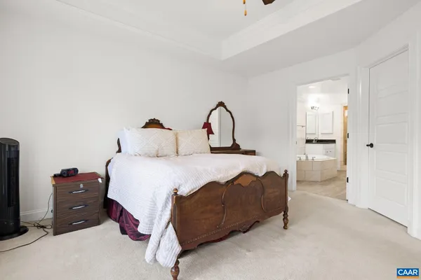 a bedroom with a bed and a television