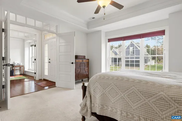 a bedroom with a bed closet and a large window