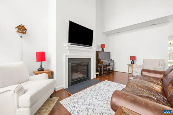 a living room with furniture fireplace and flat screen tv