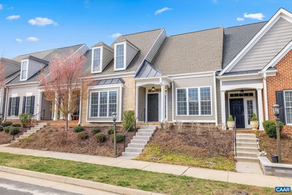 front view of a brick house with large windows