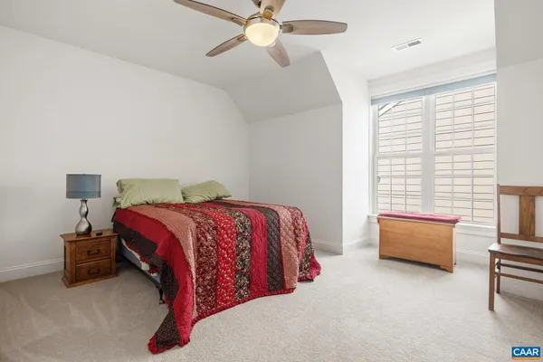 a bedroom with bed and window