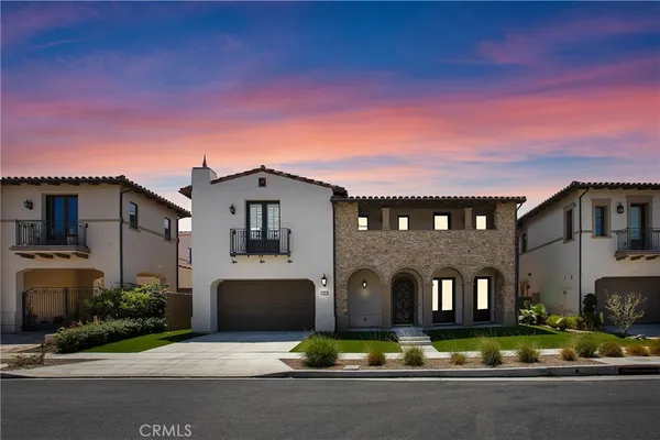 a front view of a house with yard and trees