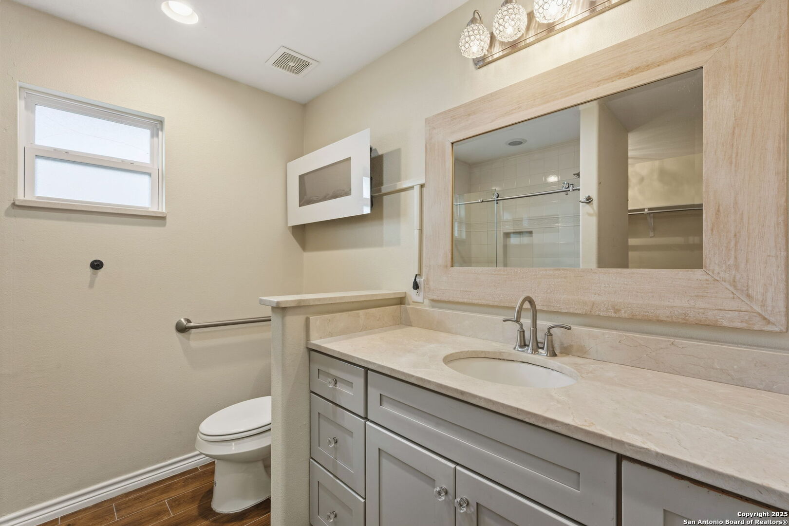 533 Indian Jourdanton, TX 78026 - Photo 17 of 27 a bathroom with a sink a toilet and mirror