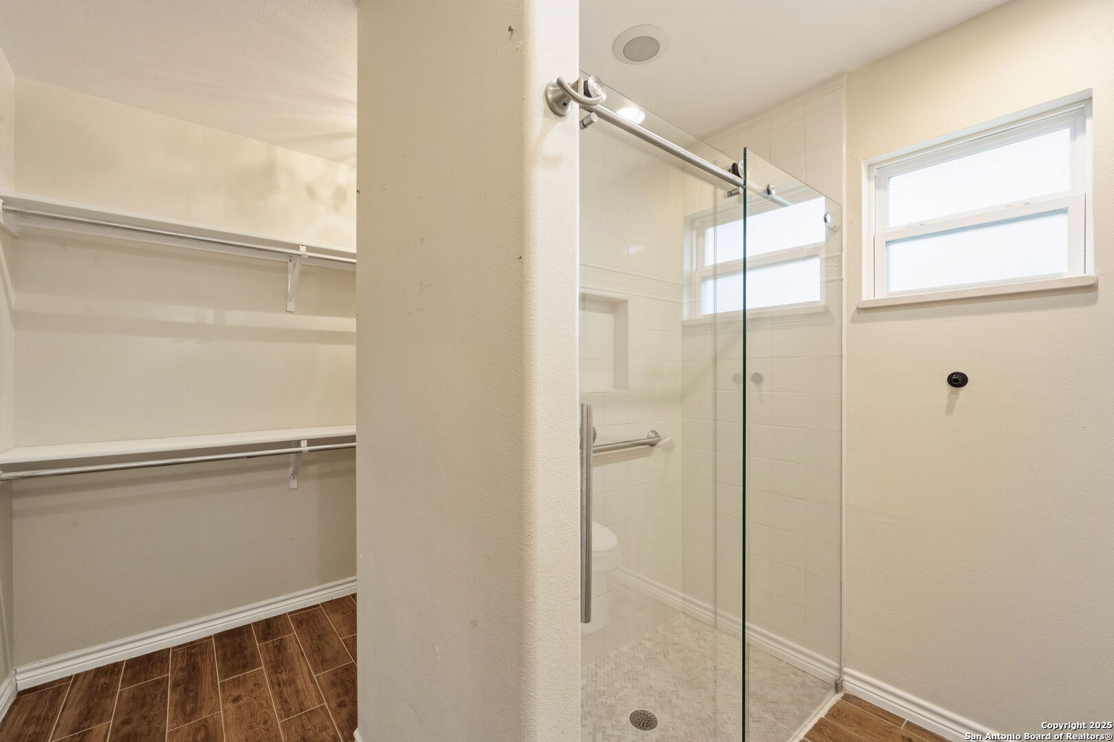 533 Indian Jourdanton, TX 78026 - Photo 18 of 27 a bathroom with a shower and a glass door