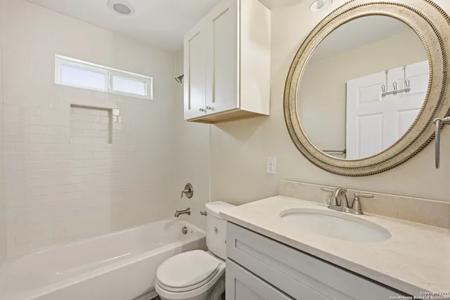 a bathroom with a sink a toilet and a mirror